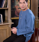 man wearing steel blue kurta top seated and posing for the camera