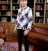 full view of man dressed in bunga raya print teluk belanga top