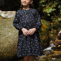 smiling girl posing in holiday dress melati print