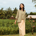 woman looking to right, posing wearing 2-in-1 kebaya top green dahlia print