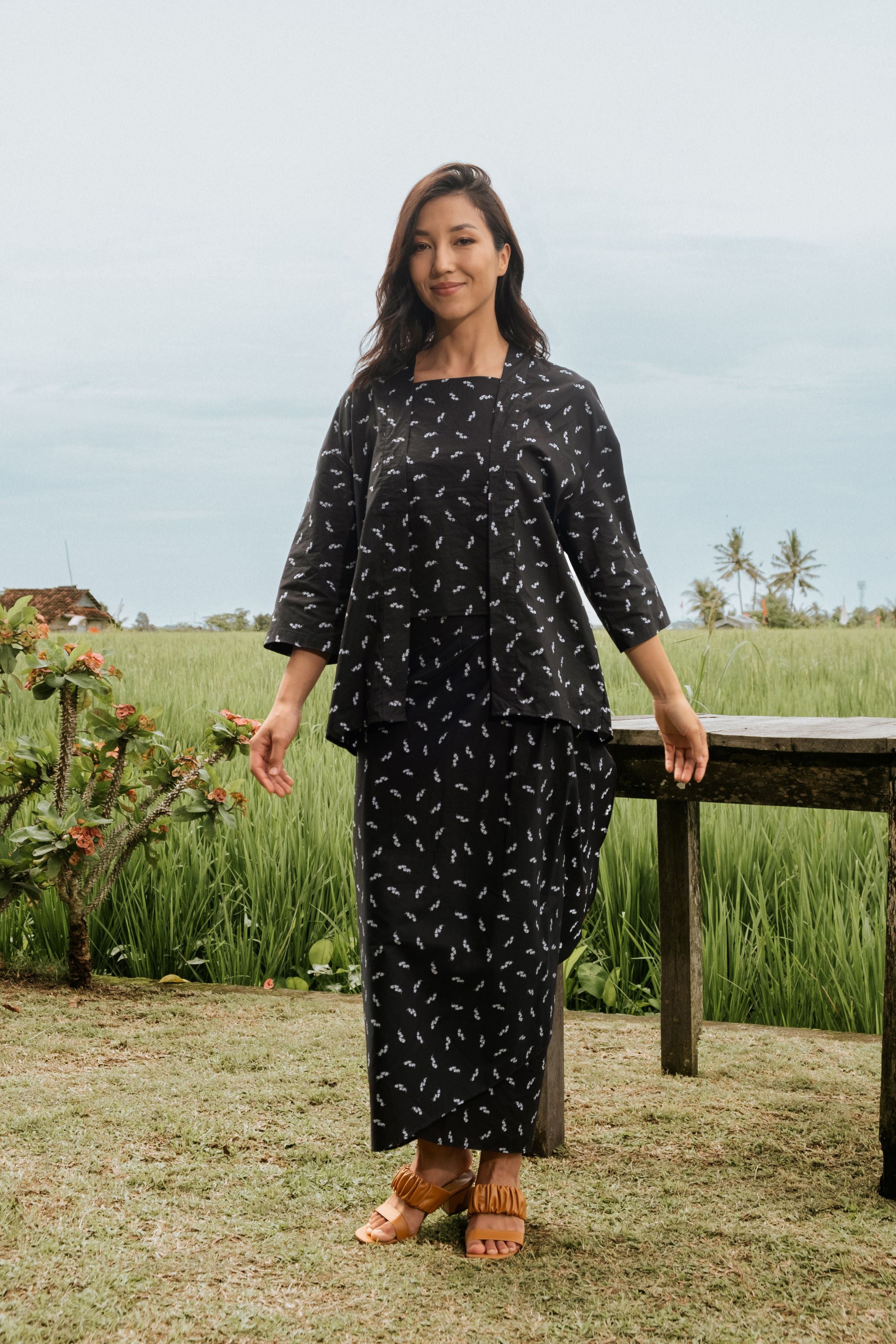 woman happily posing in 2-in-1 kebaya top melati print