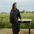 smiling woman looking to left posing in melati print 2-in-1 kebaya top