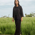 smiling woman wearing instant wrap skirt black and posing