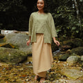 smiling woman wearing khaki instant wrap skirt posing in nature