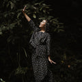 woman posing with raised hand, donning melati print instant wrap skirt  