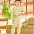 smiling young boy holding weave pattern green sampin