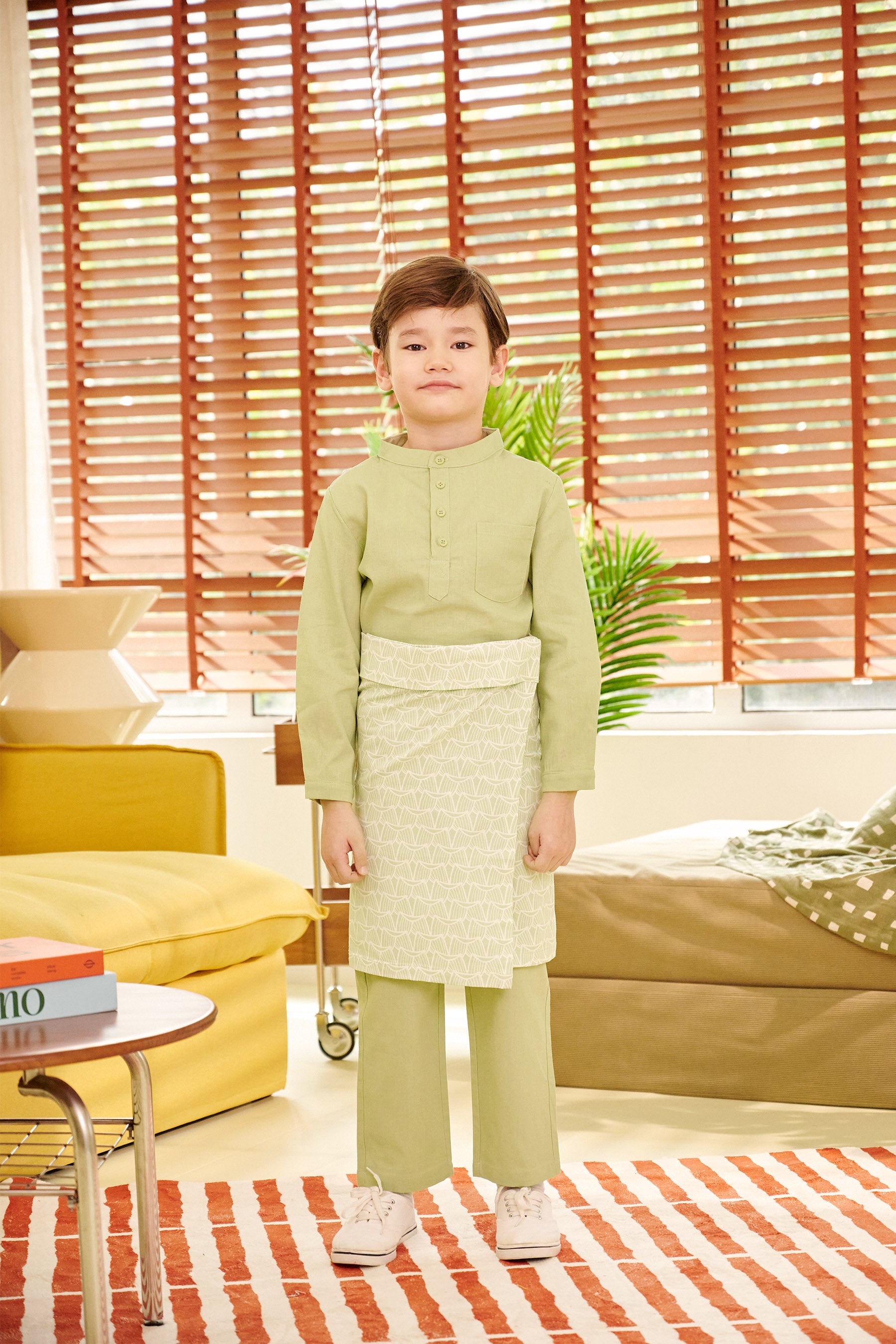 full body shot of young boy standing wearing pandan print sampin