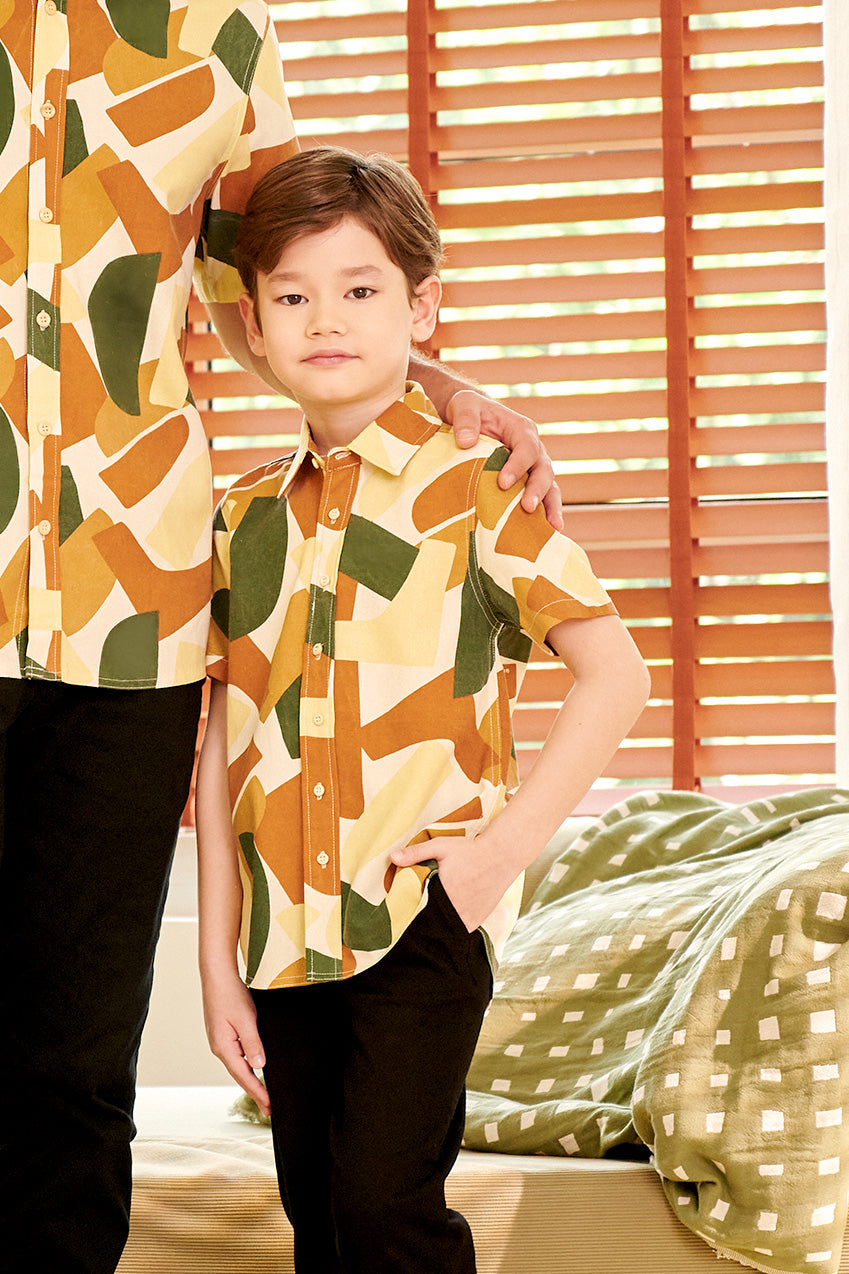 close shot of young boy wearing nasi lemak print (retro effect) short-sleeve button collar shirt