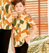 close shot of young boy wearing nasi lemak print (retro effect) short-sleeve button collar shirt