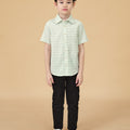 lookbook portrait of 5-6 years old boy in pandan print short-sleeve collar shirt with buttons