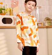 close shot of 5-6 years old boy tilting head wearing marmalade print teluk belanga top