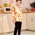 young boy tilting head standing wearing teluk belanga top marmalade print full body shot