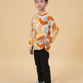 boy one hand in pocket wearing teluk belanga marmalade print top full body shot side view