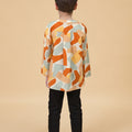 young boy posing backwards in marmalade print teluk belanga top lookbook portrait full body