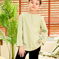 boy posing with one hand in pocket wearing mint green teluk belanga top close shot