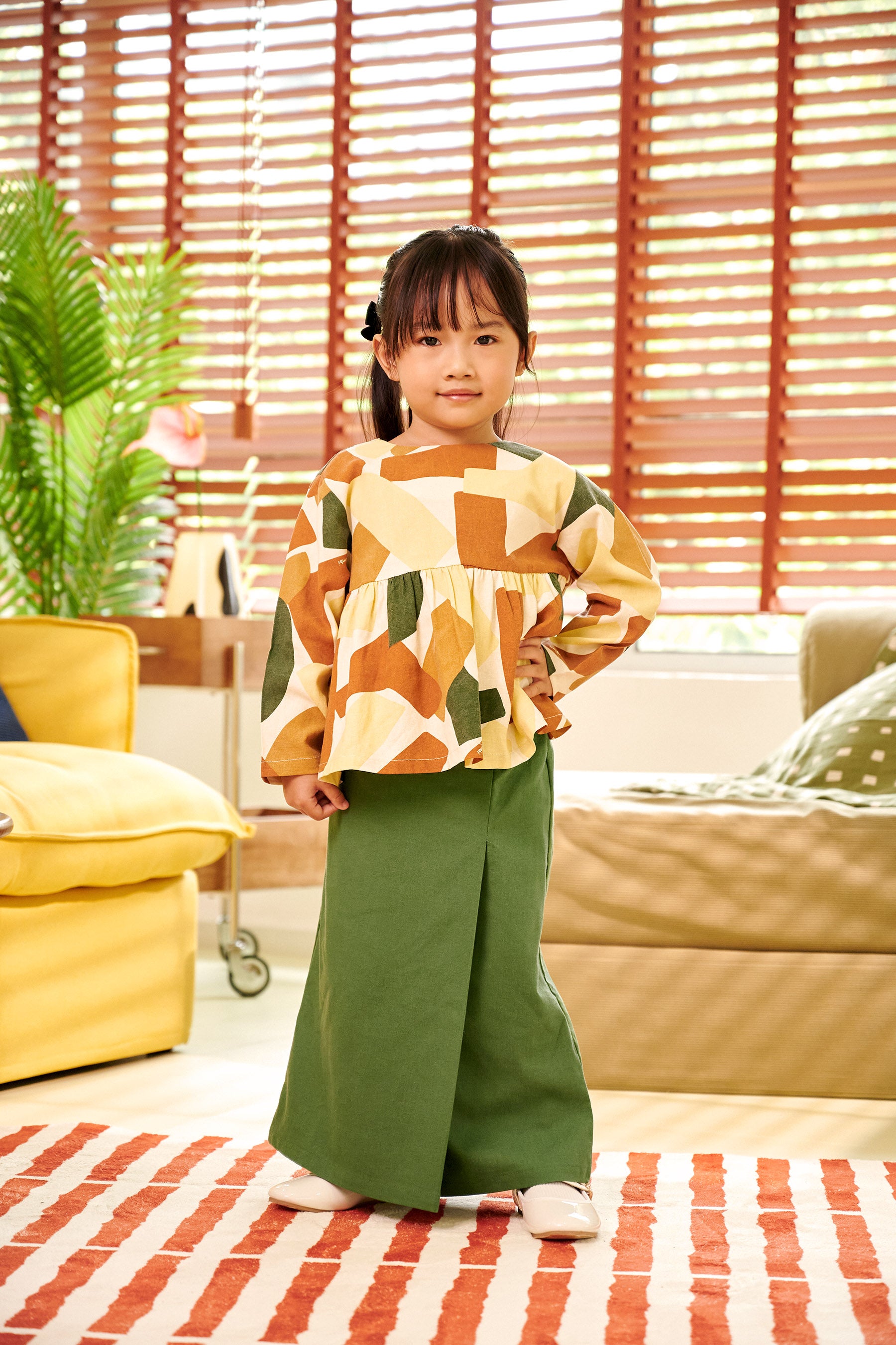 adorable little girl posing in classic skirt pine green