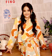 smiling young girl donning marmalade print kurung top with scallop embroidery