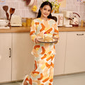 girl holding a plate of pancakes wearing kurung top with scallop embroidery marmalade print 