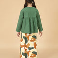 back view of young girl donning pine green ruffles top