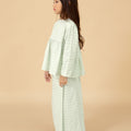 side view of young girl donning pandan print ruffles top