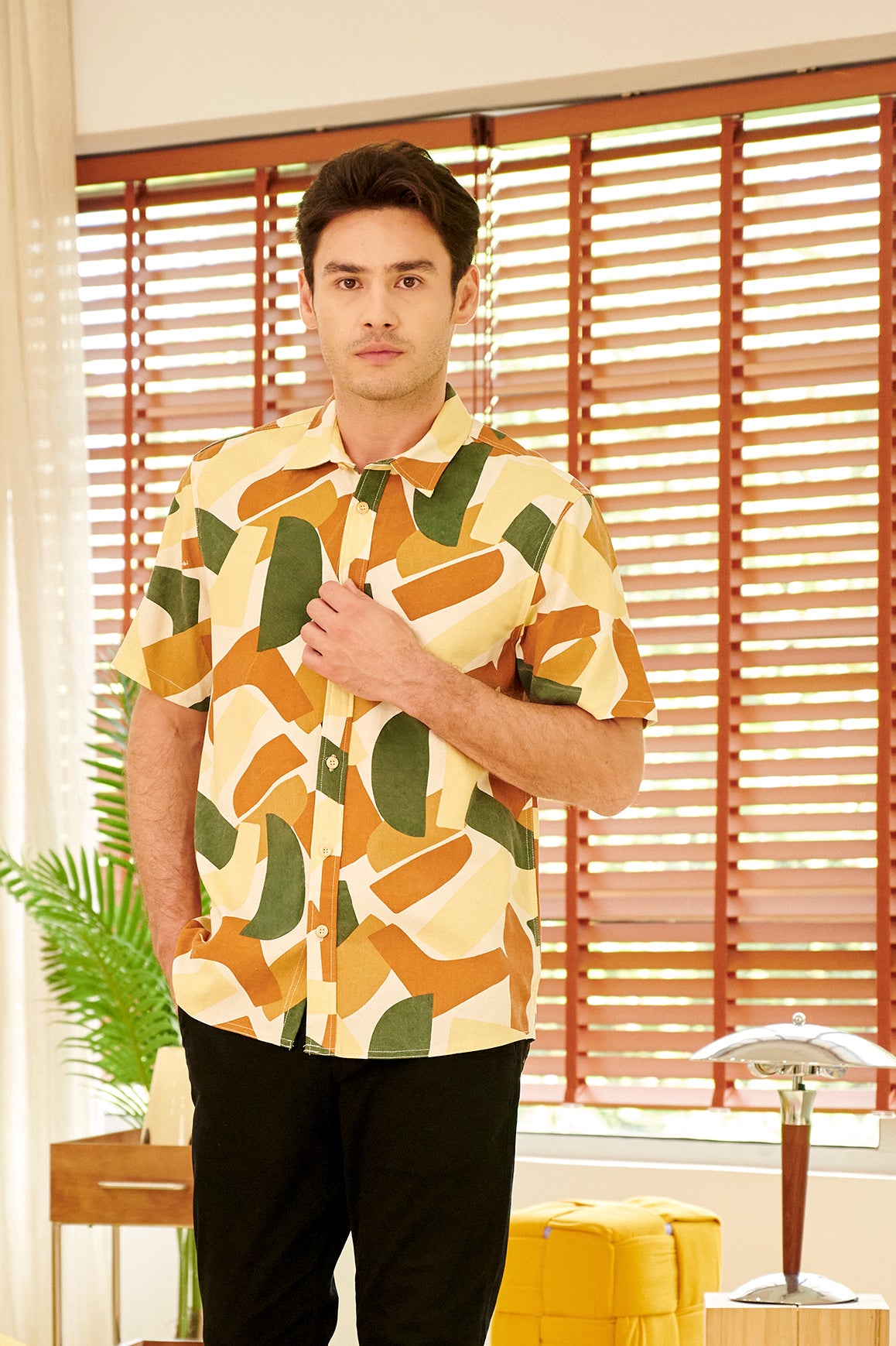 close shot of man posing standing in nasi lemak print (retro effect) holiday shirt