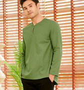 stylish man donning pine green teluk belanga looking at camera 