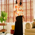 stylish woman looking away in casual blouse marmalade print 