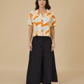 woman standing pose in marmalade print casual blouse