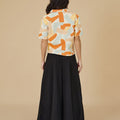 back view of woman wearing casual blouse marmalade print