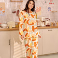 pretty woman in marmalade print kurung top with scallop embroidery looking at camera and smiling