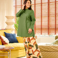 pretty woman looking sideways, posing in mandarin collar kurung top pine green