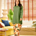 cheerful woman posing in mandarin collar kurung top pine green