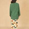 back view of woman in mandarin collar kurung top pine green