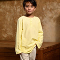 close shot of boy in butter yellow boy long sleeve kurta