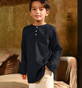 close shot of boy posing in checked black boy long sleeve kurta