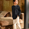 boy looking upwards posing in boy long sleeve kurta checked black