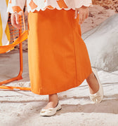 close shot of orange girl column skirt with back pleats