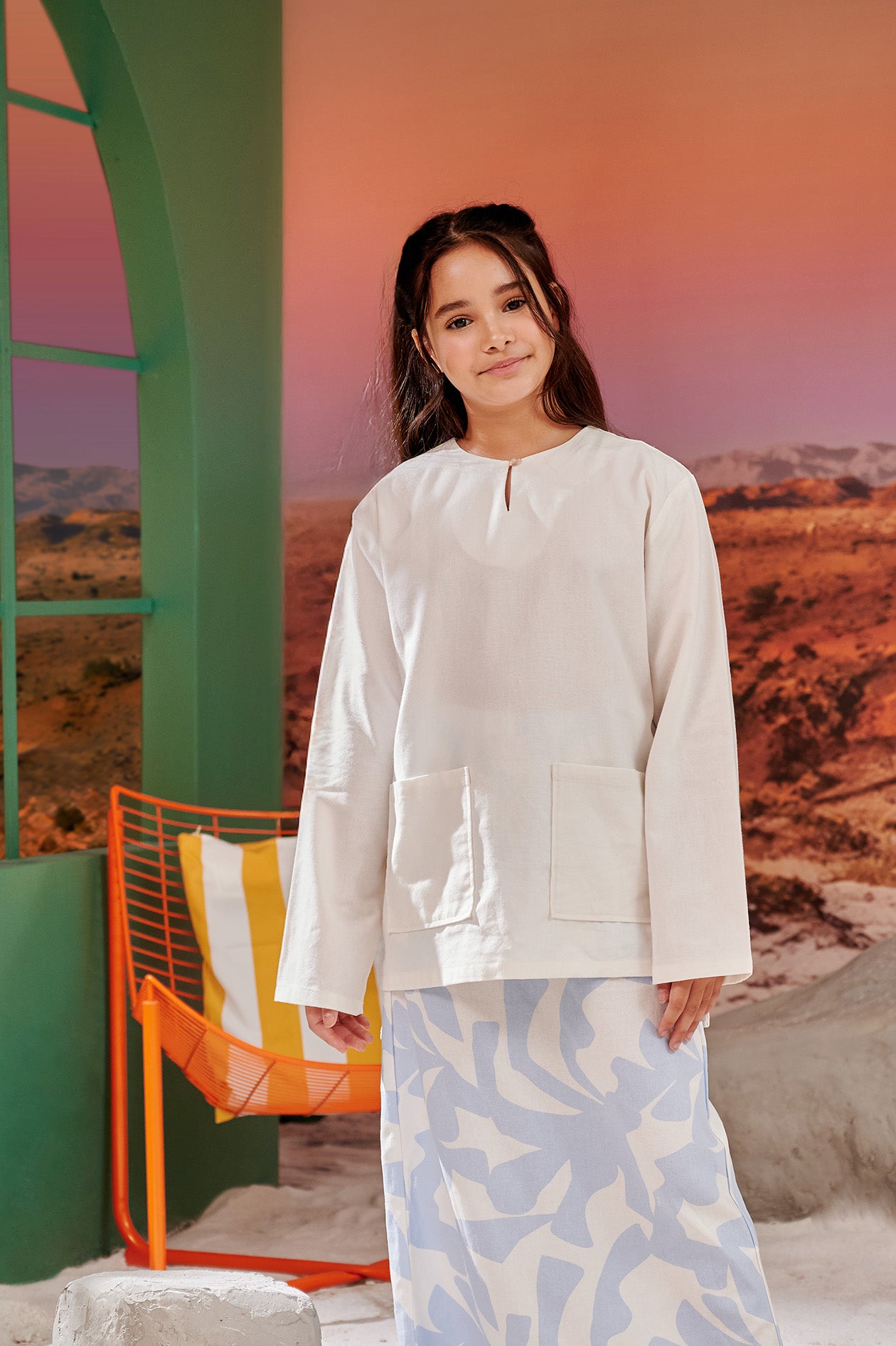 close shot of young girl in white kurung top