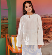 close shot of young girl in white kurung top