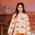 close shot of girl in desert print kurung top with scallop embroidery