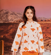 close shot of girl in desert print kurung top with scallop embroidery