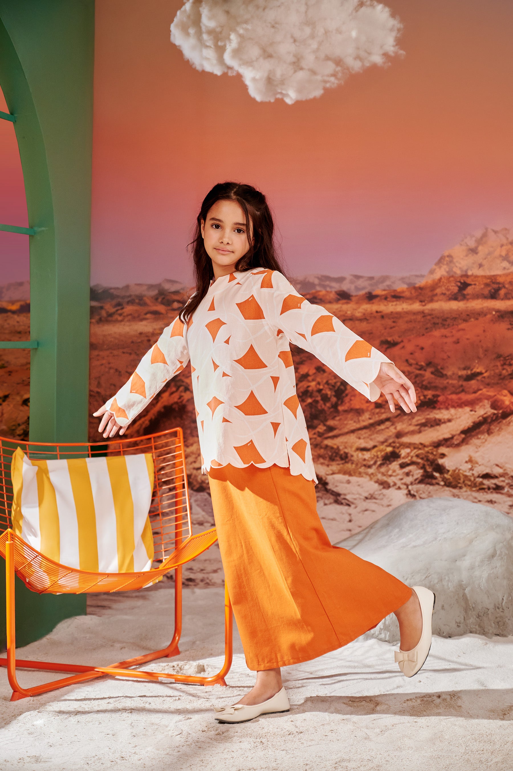 girl posing in kurung top with scallop embroidery desert print