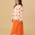 girl in kurung top with scallop embroidery desert print posing sideways