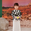 little girl holding ball wearing shadow print kurung top with scallop embroidery