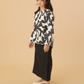 side view of girl in shadow print kurung top with scallop embroidery