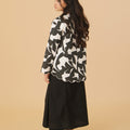 girl posing backwards wearing kurung top with scallop embroidery shadow print