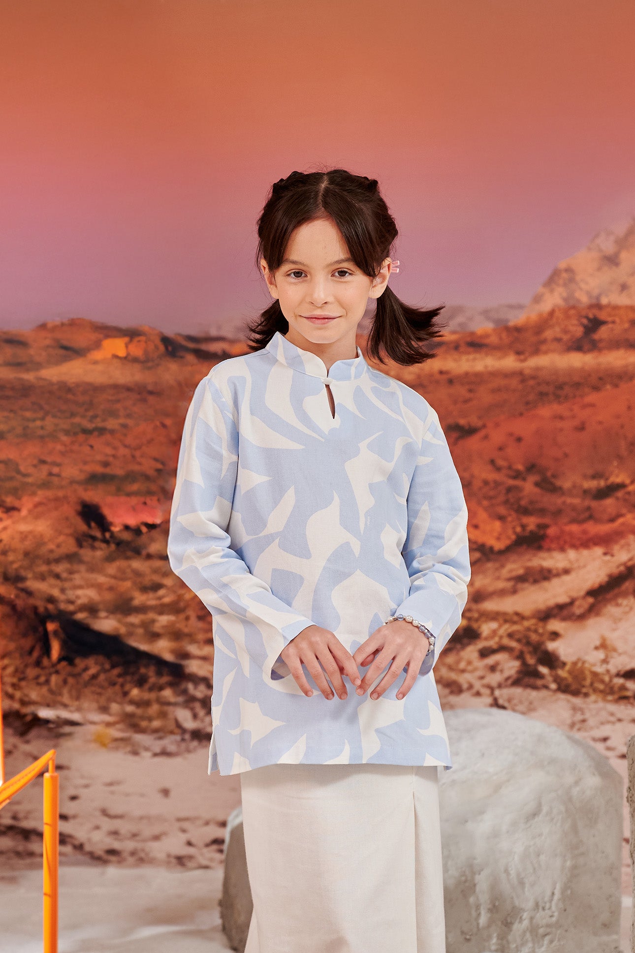 close shot of girl in mirage print mandarin collar kurung