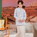 girl in mandarin collar kurung mirage print looking to camera