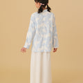 girl posing backwards wearing mandarin collar kurung mirage print