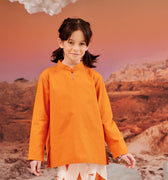 close shot of young girl in orange mandarin collar kurung top